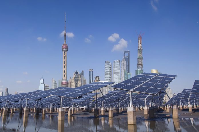 In urban areas, individual spending has increased fourfold in 20 years. But wasteful consumption is having a negative effect on the environment and the economy (Image: Jeff Hu / Thinkstock) Shanghai Bund skyline landmark ,Ecological energy renewable solar panel plant
